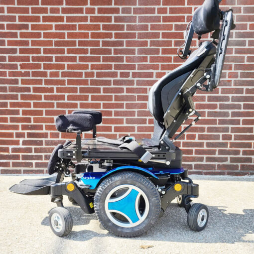 Permobil M300 Power Wheelchair in blue - left side view with armrests flipped up